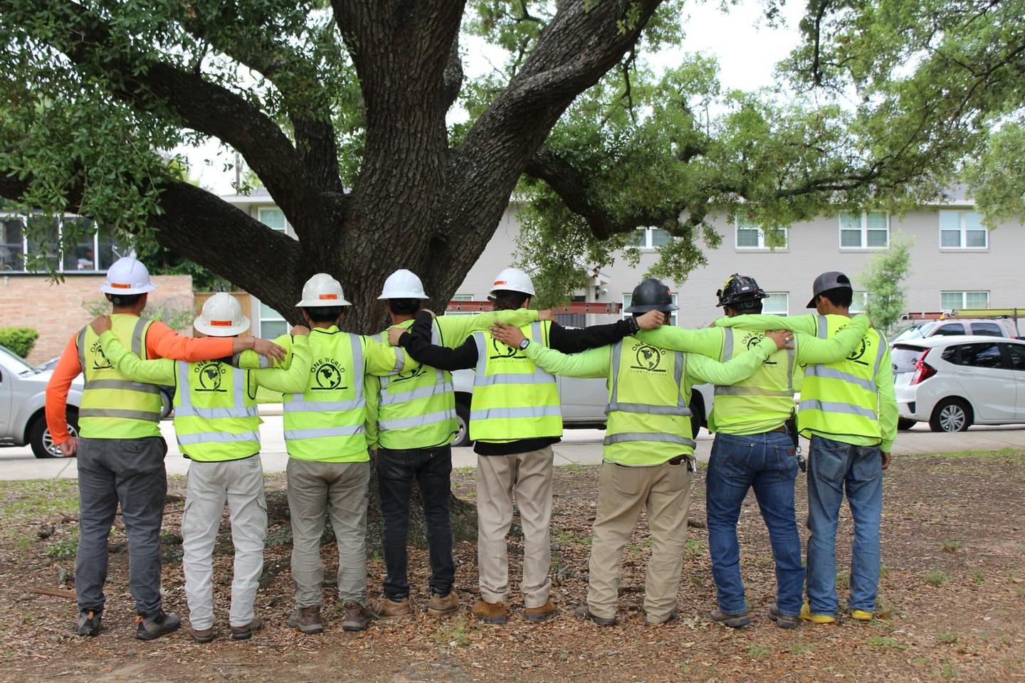 The One World Communications crew together in hard hats and high visibility vests